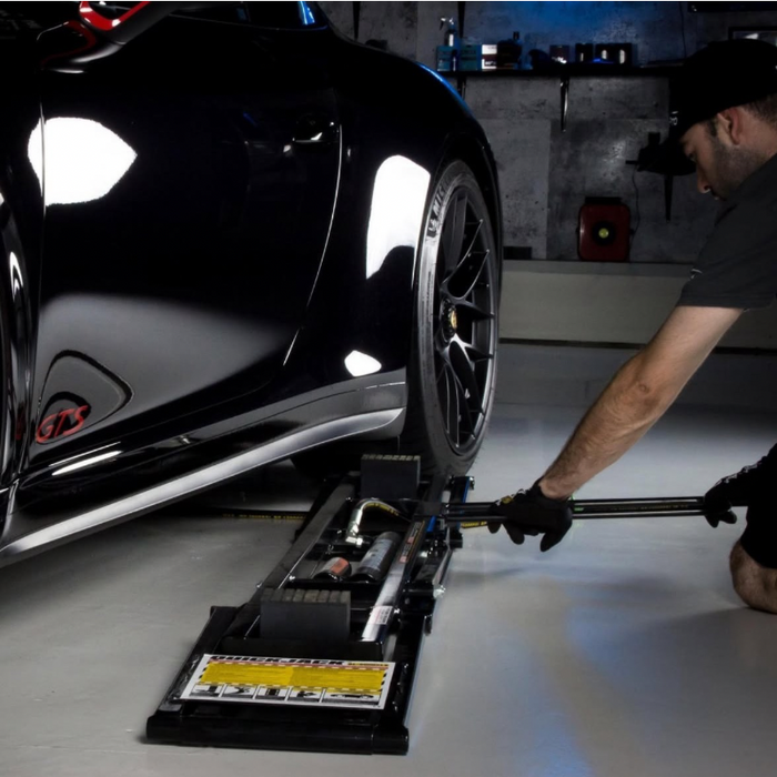 Quickjack being slid under Porsche