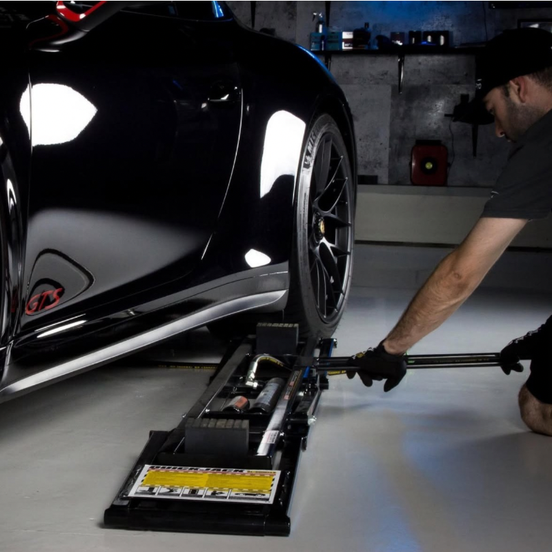 Quickjack being slid under Porsche