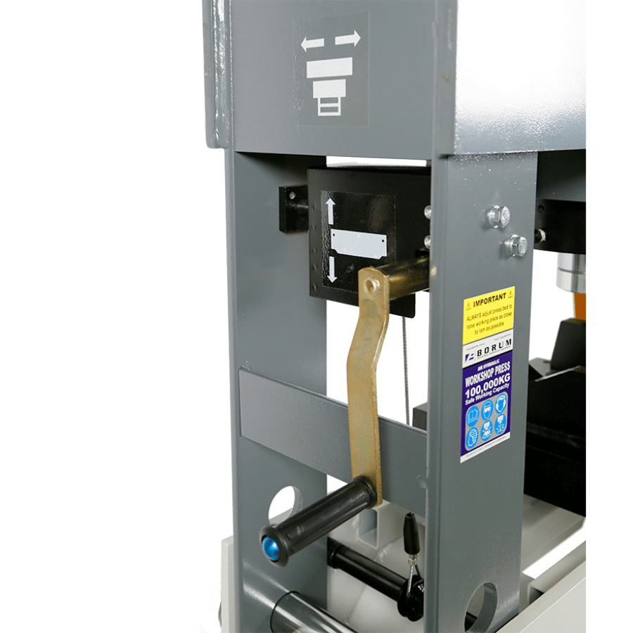 Close-up of a bsp100ta press bed with a lever and label on a white background