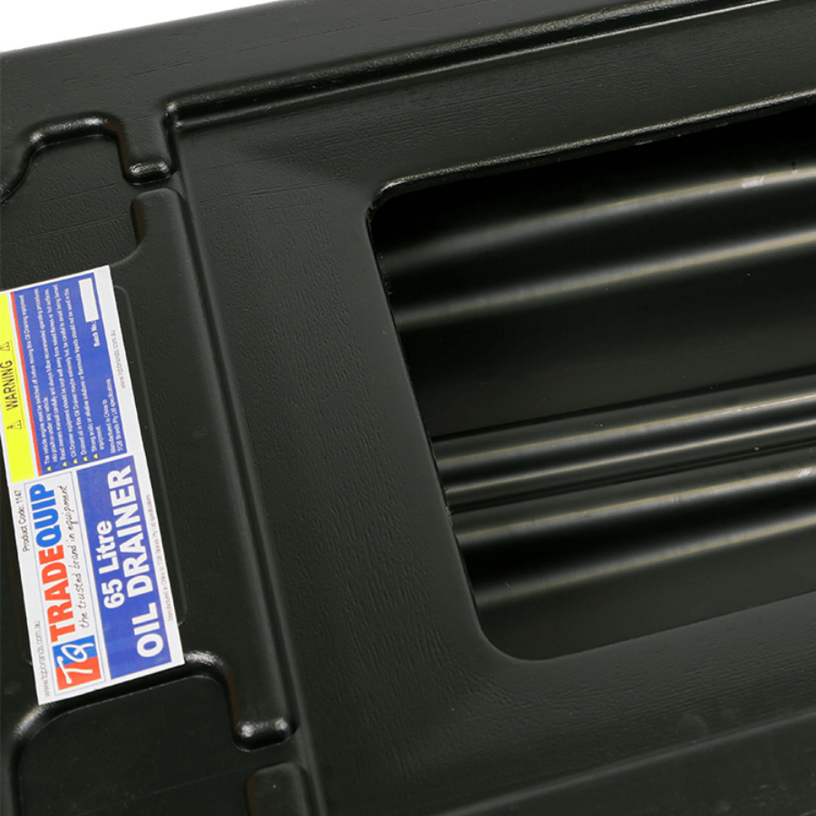 Black oil drainer with grill off and a visible label on a black background