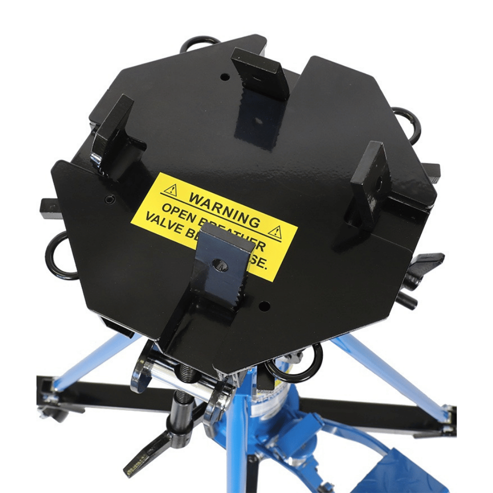 top mounting plate of a transmission jack with a yellow warning label on a white background
