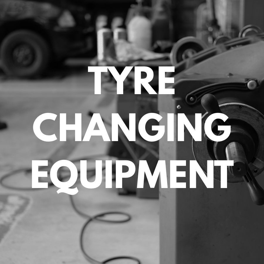 Tyre changing equipment with text overlay in a workshop setting