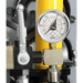 Pressure gauge on a workshop mate with a yellow background