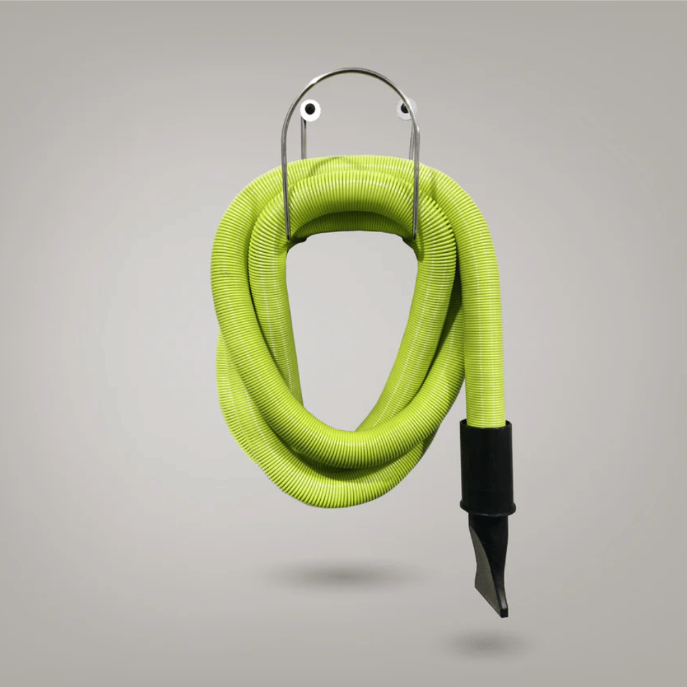 Coiled green vacuum hose with a black nozzle on a gray background