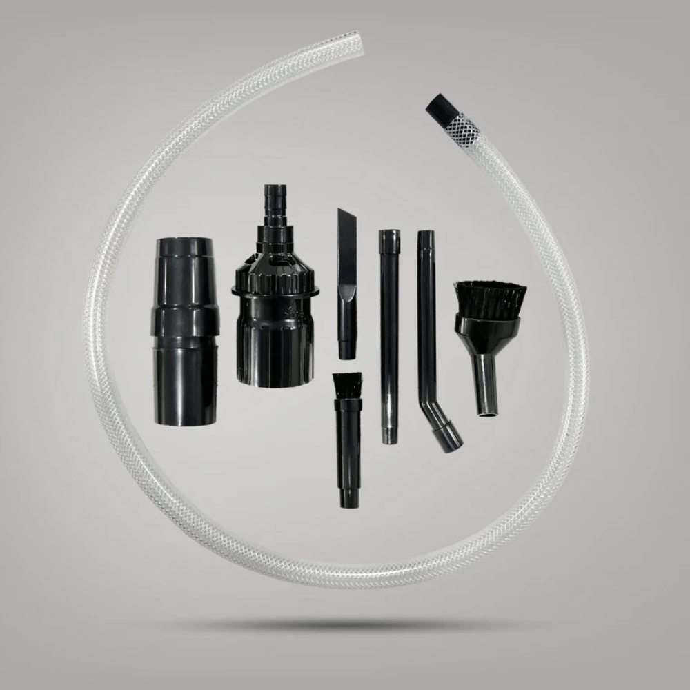 Set of black vacuum attachments on a gray background