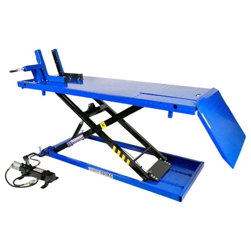 TradeQuip 2103T motorcycle lift side view with the platform raised, loading ramp down and air hydraulic foot pump